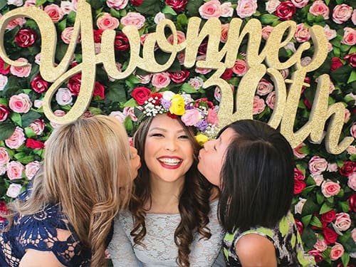 People Using a Photo Booth at a Birthday Party