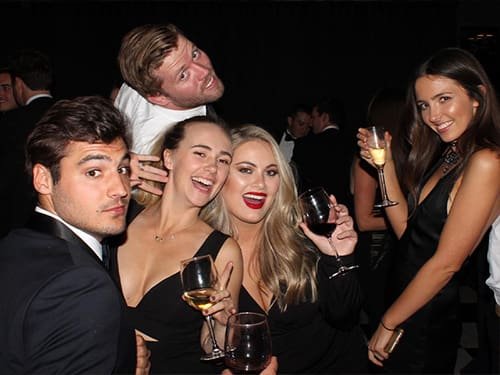 People Using Photo Booth at Formal