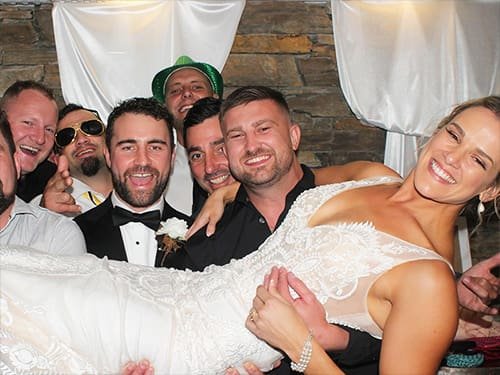 People Using a Photo Booth at a Wedding